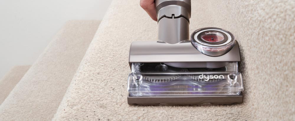 Dyson tangle free turbine tool being used on the stairs
